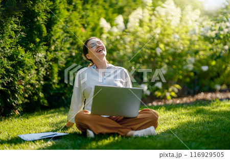 woman working on laptop in summer morning 116929505