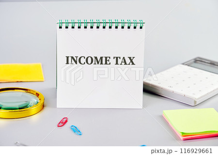 Business concept. The text INCOME TAX on a clean business notebook Business concept. The text INCOME TAX on a clean business notebook 116929661