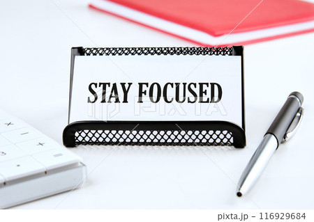 STAY FOCUSED on a business card on a white background 116929684