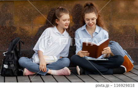 Girls with backpacks outdoors 116929818