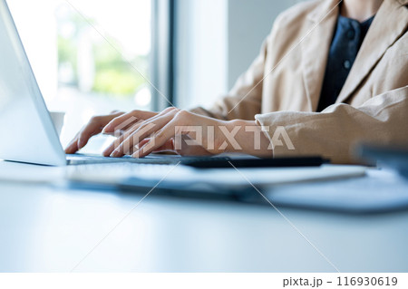 Businesswoman sitting at desk on couch 116930619