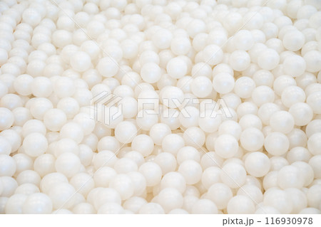 Background of many shiny white plastic balls in a ball house. It likes a many pearl in the pool. Background of many shiny white plastic balls in a ball house. It likes a many pearl in the pool. 116930978
