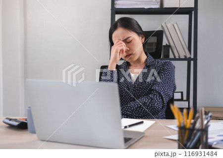Businesswoman is thinking and is stressed about work. 116931484