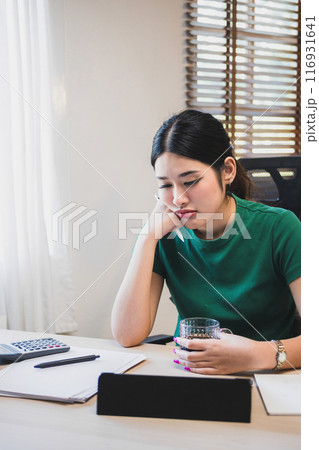 Businesswoman is thinking and is stressed about work. Businesswoman is thinking and is stressed about work. 116931641