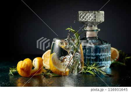 Gin tonic cocktail with lemon and rosemary. Gin tonic cocktail with lemon and rosemary. 116931645