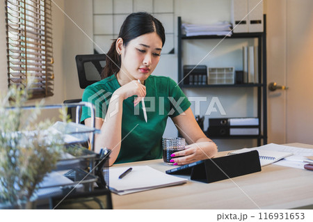 Businesswoman is thinking and is stressed about work. 116931653