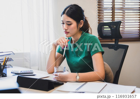 Businesswoman is thinking and is stressed about work. Businesswoman is thinking and is stressed about work. 116931657