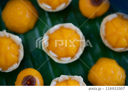 Traditional Golden Thai Dessert; JaMongKut, ThongAek are set on banana leaf. Traditional Golden Thai Dessert; JaMongKut, ThongAek are set on banana leaf. 116932007