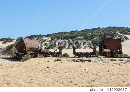 Historic Rusted Mine Carts on Sandy Beach Historic Rusted Mine Carts on Sandy Beach 116932657