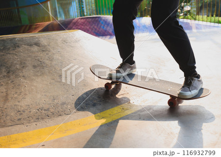 Skateboarder skateboarding at skatepark in city Skateboarder skateboarding at skatepark in city 116932799