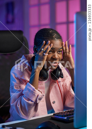 Vertical portrait of frustrated teenage girl watching intense videos online on PC Vertical portrait of frustrated teenage girl watching intense videos online on PC 116933333