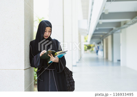 Muslim student in university wearing black niqab. Arab black chador lady. 116933495