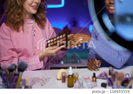 Close up of two young women recording make up review video and testing beauty products copy space Close up of two young women recording make up review video and testing beauty products copy space 116933559
