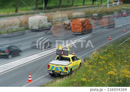 Police car directing traffic on highway. Selective focus 116934169