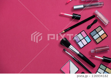 Various decorative cosmetics and brushes on a pink background, copy space for text 116934182