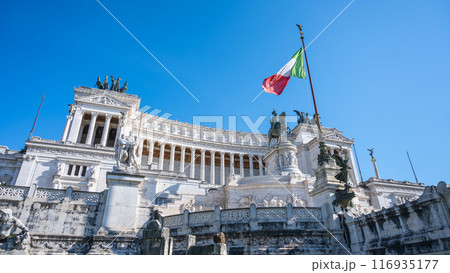 The Vittoriano, a grand marble monument in Rome, Italy, honors Victor Emmanuel II. The Italian flag flies proudly atop the structure, a symbol of national pride. 116935177