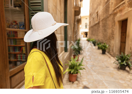 Young girl walking on the street in old village, Mallorca 116935474