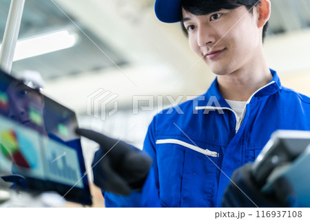 システムで在庫確認をする若い男性社員 116937108