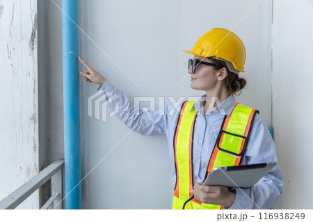 Construction civil engineer woman using tablet checking quality water pipes 116938249