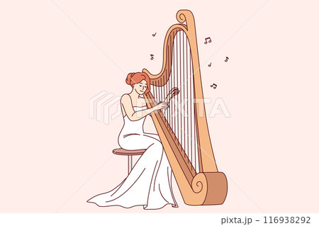 Woman plays large harp, performing at symphony concert or classical music festival 116938292