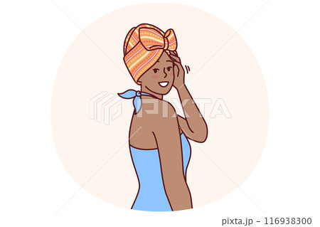 African American woman with traditional turban on head is dressed in blue dress for ethnic party 116938300
