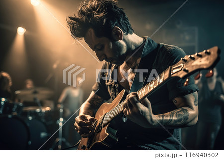 Rock Musician Playing The Guitar Solo On A Stage, Band Playing Concert 116940302