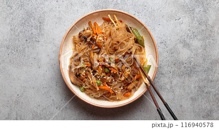 Bowl of japchae, korean glass noodles stir fry with vegetables and mushrooms Bowl of japchae, korean glass noodles stir fry with vegetables and mushrooms 116940578