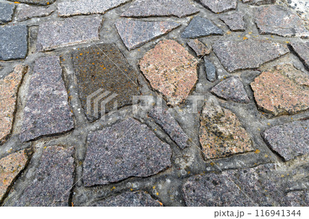 Background cobblestone road close-up. Stone pavement. 116941344