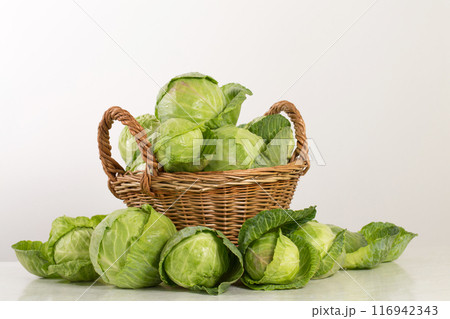 Fresh young cabbage in a wicker basket 116942343
