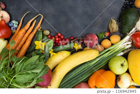 A variety of fruits, vegetables and berries laid out with a place for writing A variety of fruits, vegetables and berries laid out with a place for writing 116942945