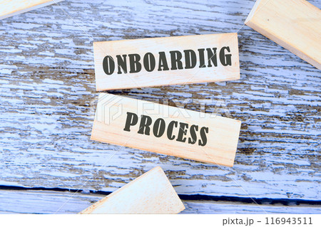 Onboarding Business Process New Employee Welcome Concept. Onboarding worker management. ONBOARDING PROCESS on wooden blocks, a conceptual phrase against the background of old boards 116943511