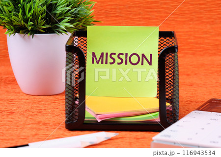 Mission word on a light green ticker in front of an orange background 116943534