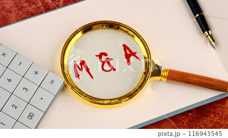 M and A Mergers and Acquisitions word concept. M and A through a magnifying glass in red provocative letters 116943545