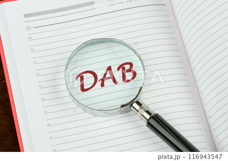 DAB Written through a magnifying glass on a notepad page DAB Written through a magnifying glass on a notepad page 116943547