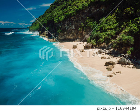 Drone view of scenic coastline with turquoise ocean and tropical sandy beach in Bali island. 116944194