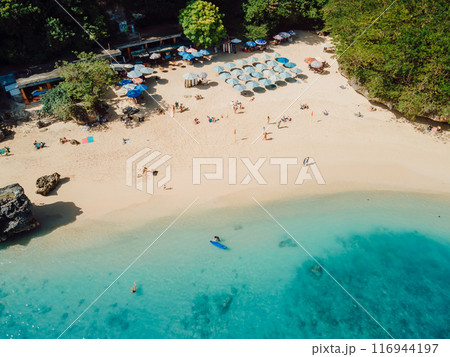Holiday beach with turquoise clear ocean in Bali. Aerial view of popular touristic beach, Padang Padang 116944197
