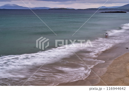 long exposure beach waves around rock cloudy day long exposure beach waves around rock cloudy day 116944642