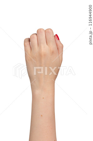 Female hand in a fist, showing knuckles with red manicured nails, dorsal view. Elegant gesture, 116944900
