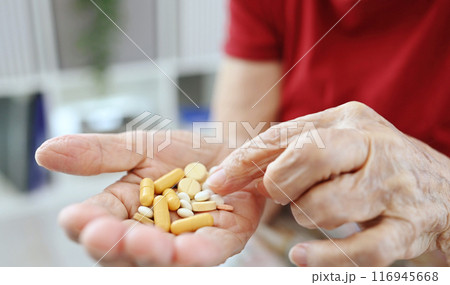 Elderly Woman Counts Pills And Capsules In Her Palm Elderly Woman Counts Pills And Capsules In Her Palm 116945668