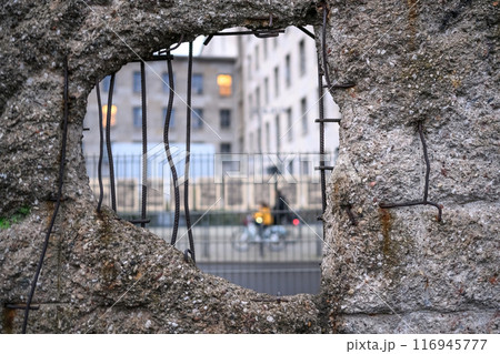 Hole in Broken Berlin wall and walking person against Hole in Broken Berlin wall and walking person against 116945777