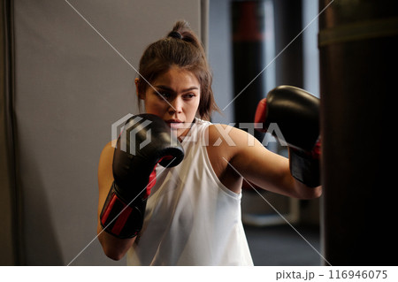 Exercising in modern gym during training 116946075