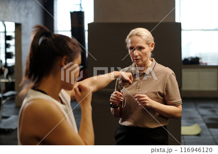 Trainer giving advice to female boxer 116946120