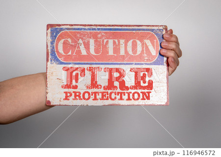 Fire Protection. Caution sign with text in hand 116946572