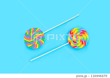 Rainbow lollipop on blue background. Rainbow lollipop on blue background. 116946870
