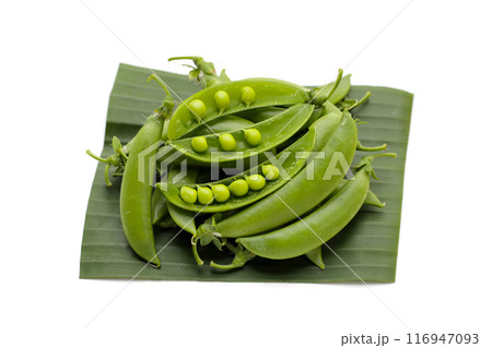 Fresh young green peas on white background. 116947093