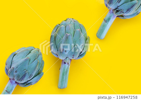 Fresh artichoke on yellow background. Fresh artichoke on yellow background. 116947258