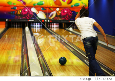 The guy is bowling. Rear view. 116948328