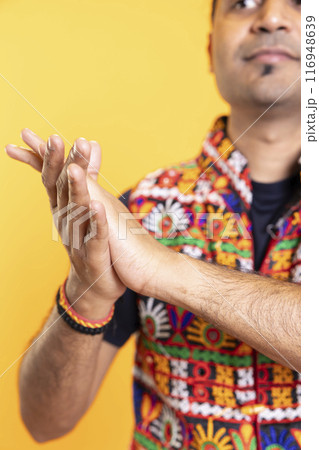 Close up shot of spectator clapping hands, praising entertainers, studio background. Person reacting to spectacle by applauding, doing standing ovation, isolated over studio backdrop Close up shot of spectator clapping hands, praising entertainers, studio background. Person reacting to spectacle by applauding, doing standing ovation, isolated over studio backdrop 116948639