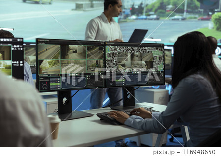 Indian leader supervises his staff in control center to work on traffic surveillance by following real time CCTV video. Diverse agency employees examining city streets via satellite radar. Indian leader supervises his staff in control center to work on traffic surveillance by following real time CCTV video. Diverse agency employees examining city streets via satellite radar. 116948650