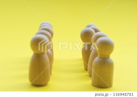 A wooden figure looking as if he or she is disagreed with something. Concept of speak up. 116948781